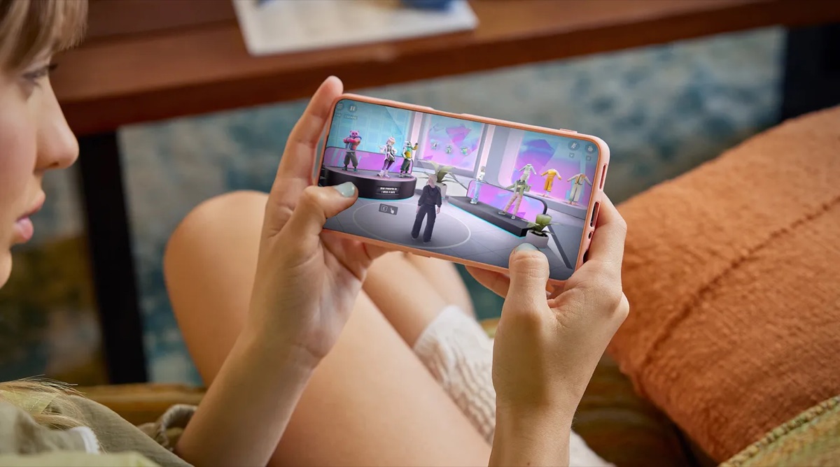 A young person immersed in interactive content on a phone — safe, age-appropriate experiences